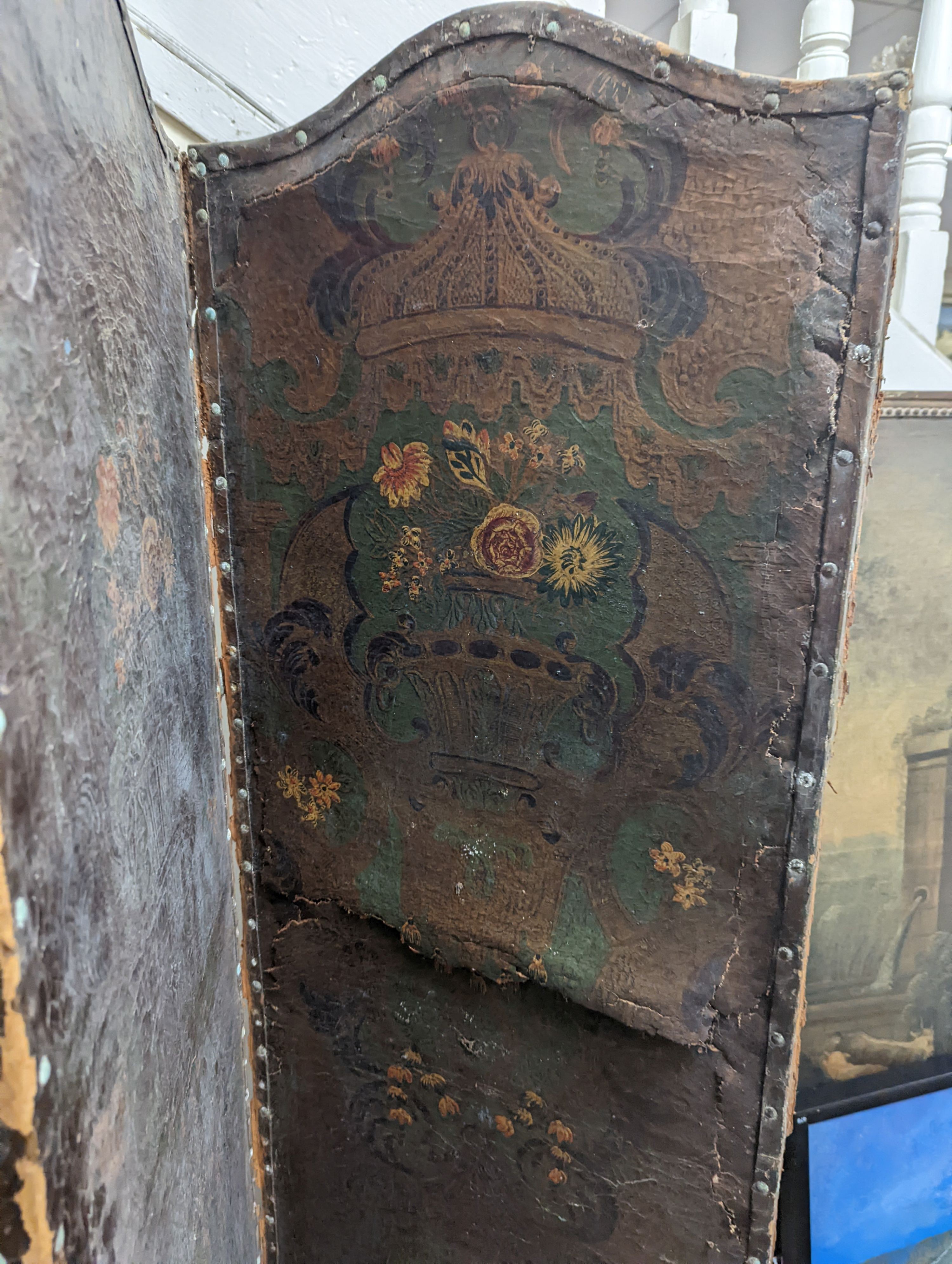 A Spanish painted leather four fold dressing screen, each panel width 45cm, height 176cm